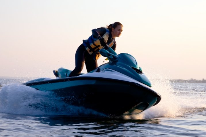 Person operating a jet ski on open water during daytime