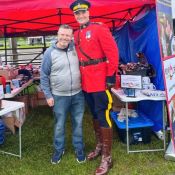 Executive Director of the RCMP Foundation poses with the Officer in Charge of the Musical Ride, dressed in Red Serge.