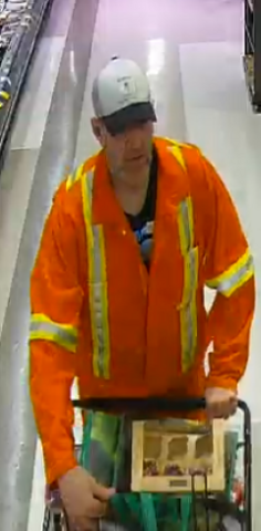 Security footage shows a person in orange coveralls and a white hat who is suspected of stealing from a store