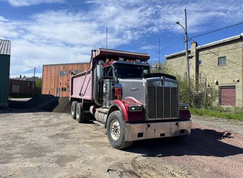 A grey and red dump truck