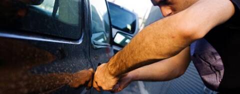 Man breaking into a car